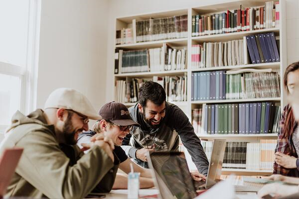 three men having fun during a hackathon